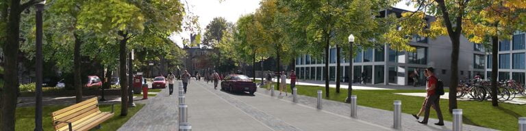 Photo of Queen's University students walking across campus.