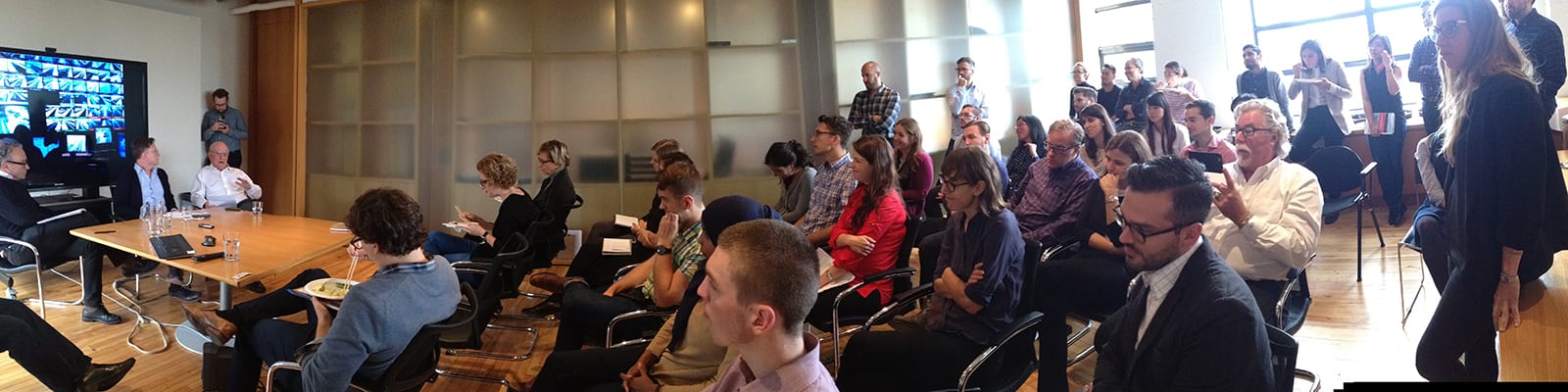 Group of people listening to a presentation.