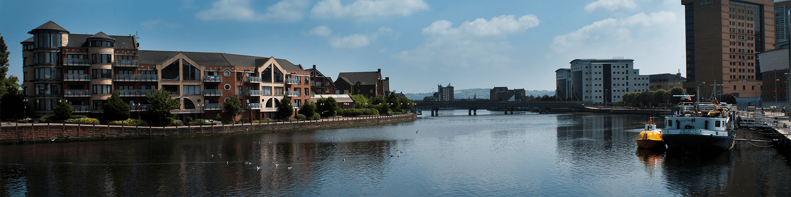 A body of water with buildings in the background.