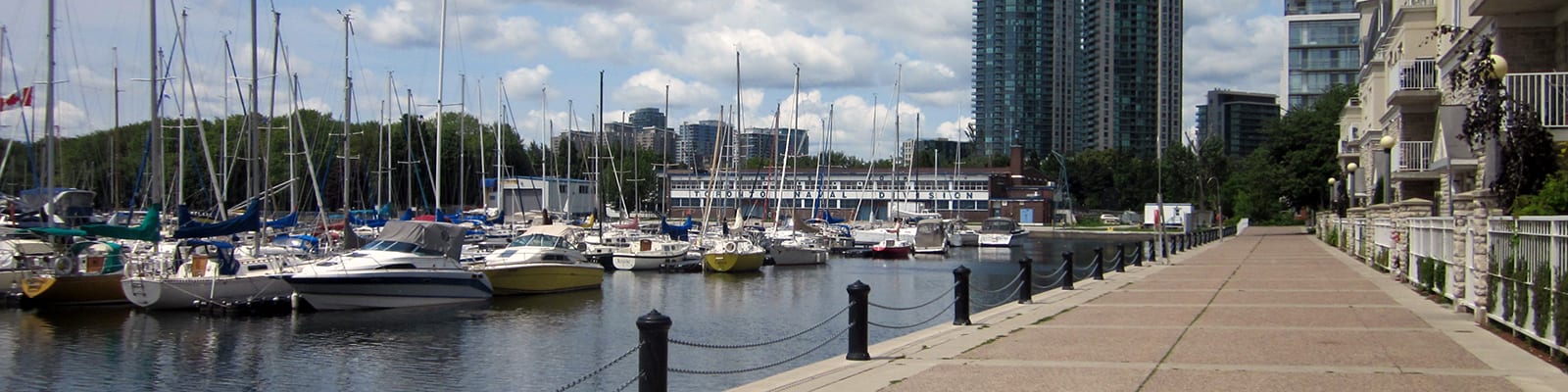 Waterfront walkway with boats in the background.