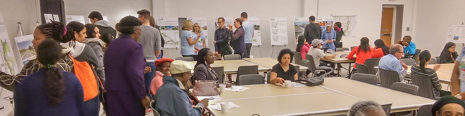 People walking around at an engagement panel.