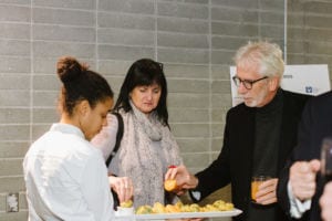 People taking food from a server.