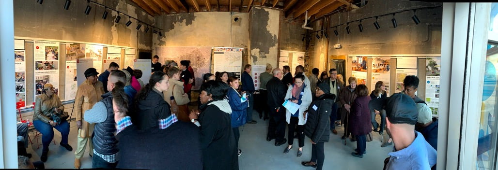 People reading engagement panels at a community engagement session.