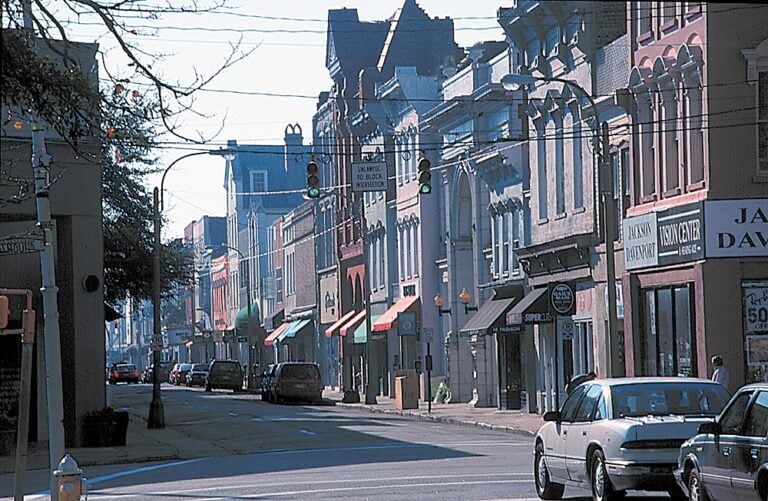 Photo of downtown Charleston street with businesses and cars parked.
