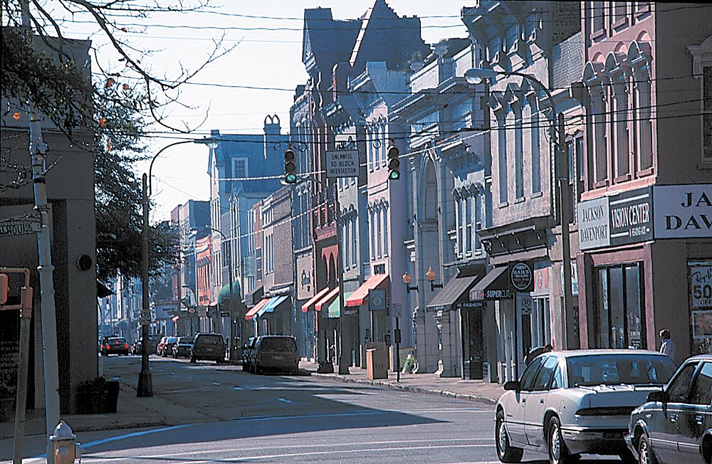 Photo of downtown Charleston street with businesses and cars parked.