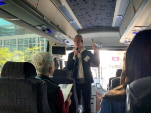 USI staff member talking on a coach bus