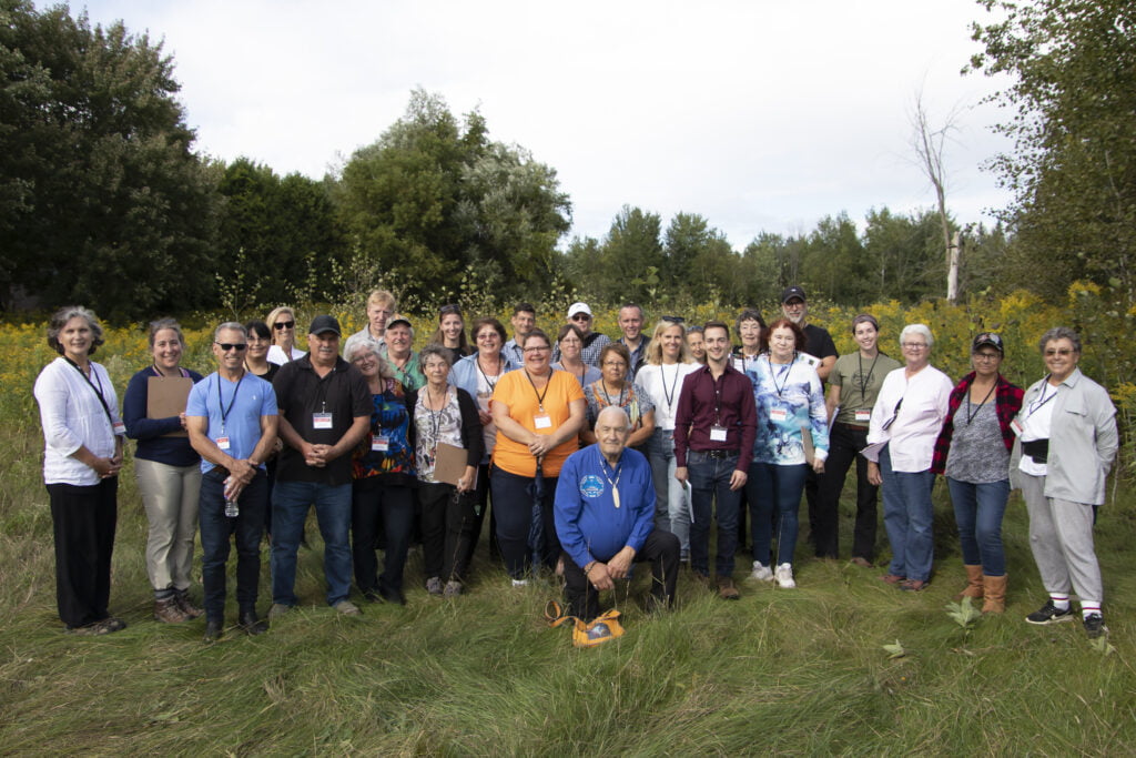 Group of people and staff smiling.