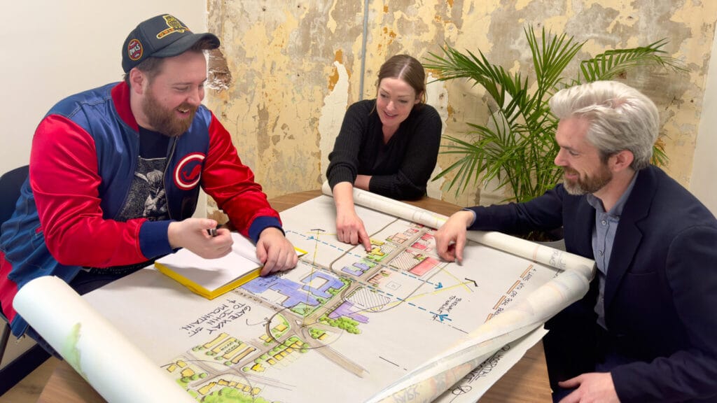 USI Staffs pointing at the map in Hamilton Office
